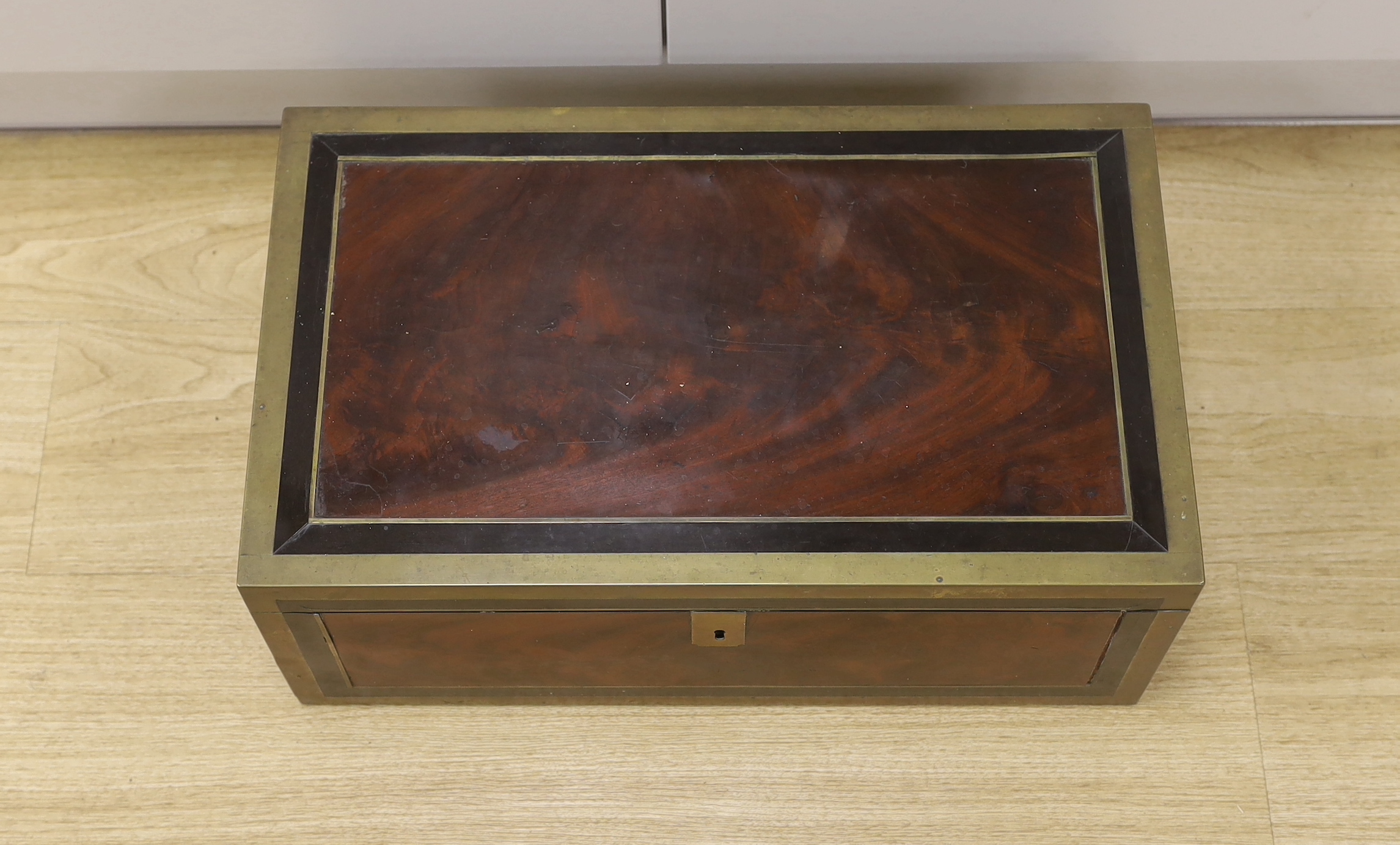 A George III mahogany, ebony and brass-mounted ship's writing box by Wells & Co., screw fixings to each side with original key, 50.5cm x 30cm x 19.5cm